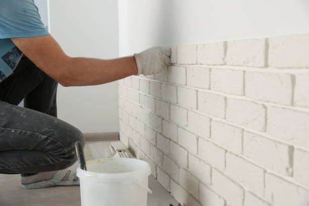 istock Worker installing decorative wall tiles in room, closeup 1489280026