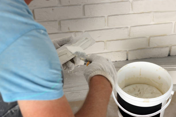 istock Worker installing decorative wall tiles in room, closeup 1489280027