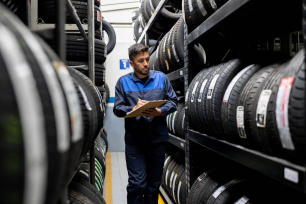 istock Man doing a stock inventory while working at a tire factory 1489285886