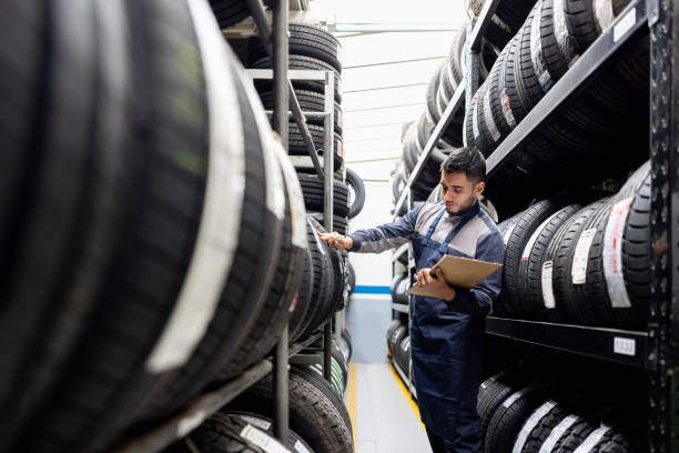 istock Man doing a stock inventory while working at a tire factory 1489285892
