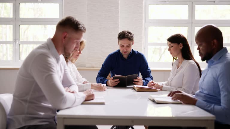 Group Of Young Multiethnic People Reading Bible Over Wooden