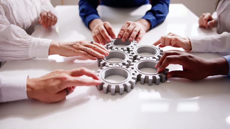 Diverse People Hands Holding Gear Wheels