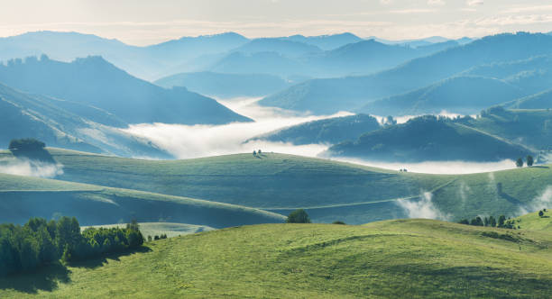 Mountains and hills in morning light, fog
