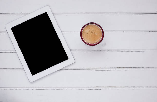 Cup of coffee with digital tablet