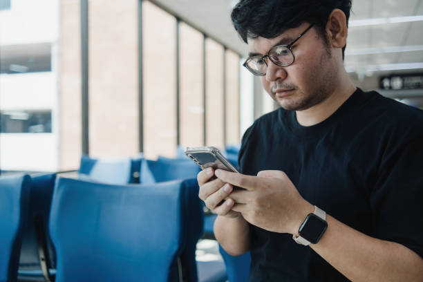 istock Chatbot gpt concept, asian man sitting down while looking at his smartphone, Humanizing digital experiences. 1489315863