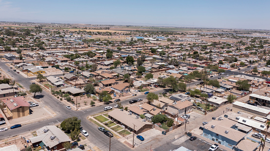 El Centro, California, USA - May 27, 2022: Afternoon sunlight shines on housing in the urban downtown core of El Centro.
