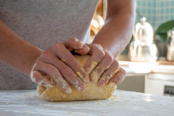 istock Woman kneading dough on kitchen counter 1489317631
