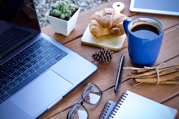 Work desk with a cup of hot coffee in the morning on a nice day.