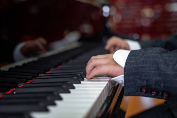 istock A pair of boy's hands are playing the piano 1489322530