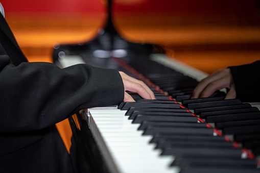 Hands of a child practicing the piano