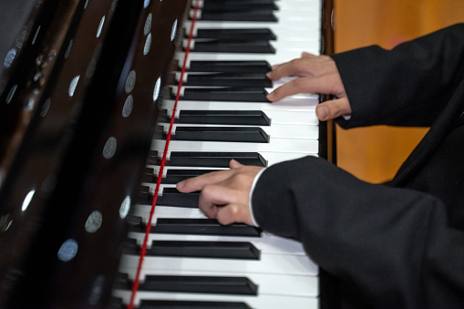 Hands of a child practicing the piano