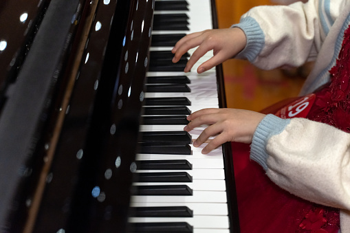 A child's hands on the piano