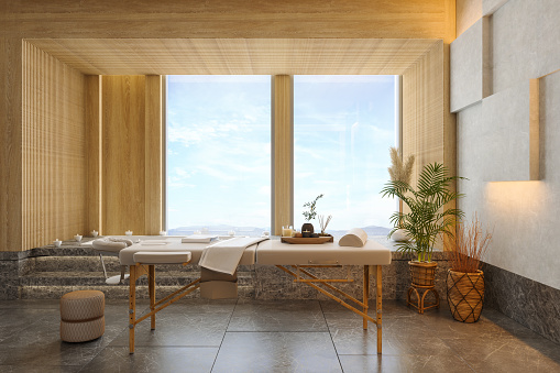 Luxury Spa Massage Room Interior With Massage Table, Hot Tub, Marble Floor And Seaview Through The Window. 3D Rendering