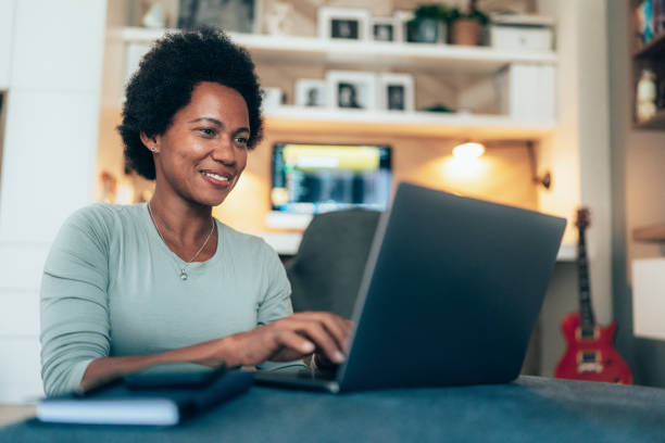 istock Woman with laptop at home 1489330543