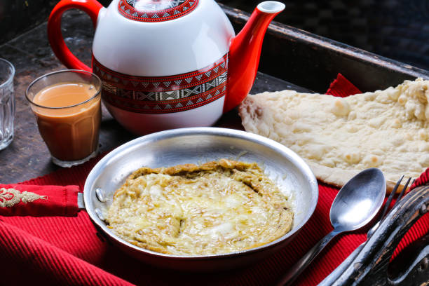 istock Egg Omelet with bread, coffee and teapot breakfast served in dish isolated on red mat top view on table arabic food 1489333273