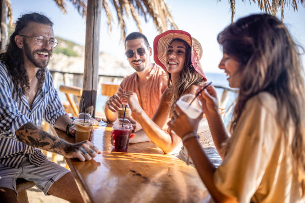 istock Group of friends having fun at beach bar 1489333894