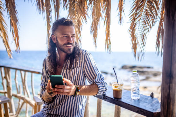 istock Young man at the beach bar 1489335099