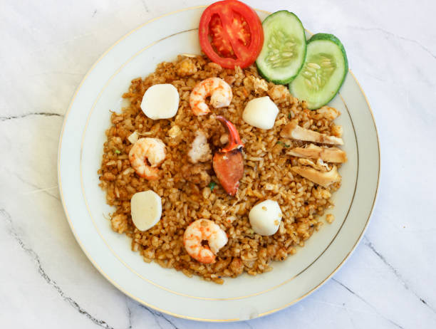 istock Nasi goreng seafood in white plate with white background. 1489336007
