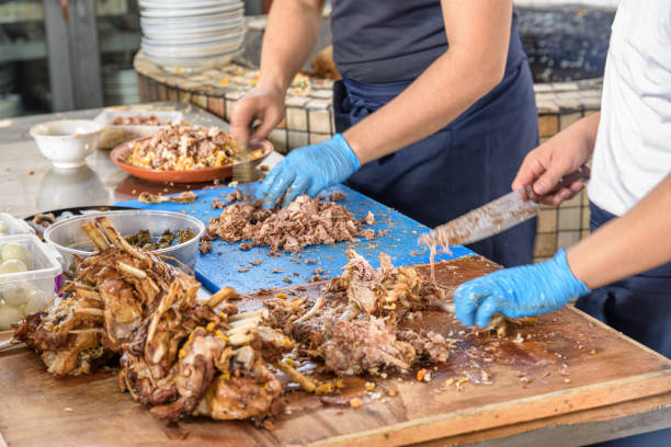 istock Cookers are cutting meat from plov (pilaf) for serving, Tashkent 1489339839