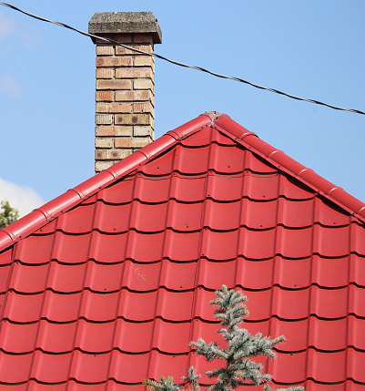 Smoke stack and red tiles on the roof of a house