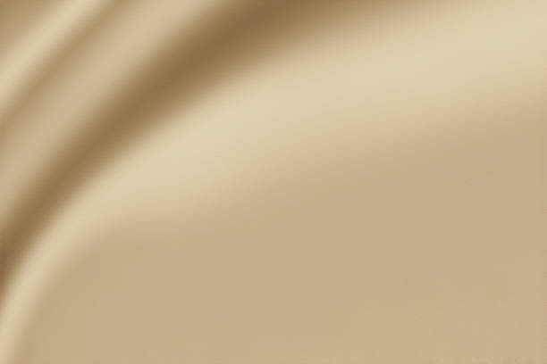 istock A luxurious smooth and elegant beige satin background with earthy or gold-colored fabric 1489341333