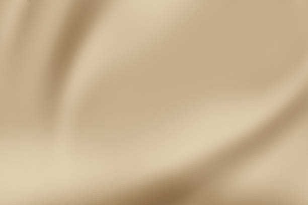 istock A luxurious smooth and elegant beige satin background with earthy or gold-colored fabric 1489341350