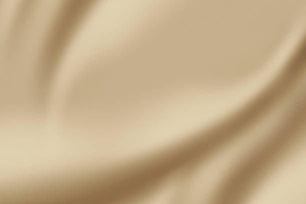 istock A luxurious smooth and elegant beige satin background with earthy or gold-colored fabric 1489341397