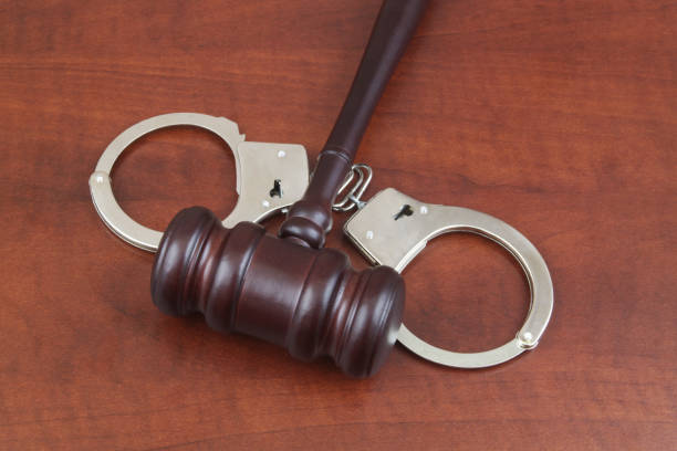 istock Judge gavel and handcuffs on table close up. 1489348003