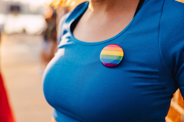Close up of a rainbow brooch on a girl’s t-shirt