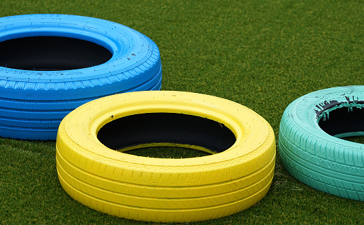 Colorful tires placed on the ground of the playground