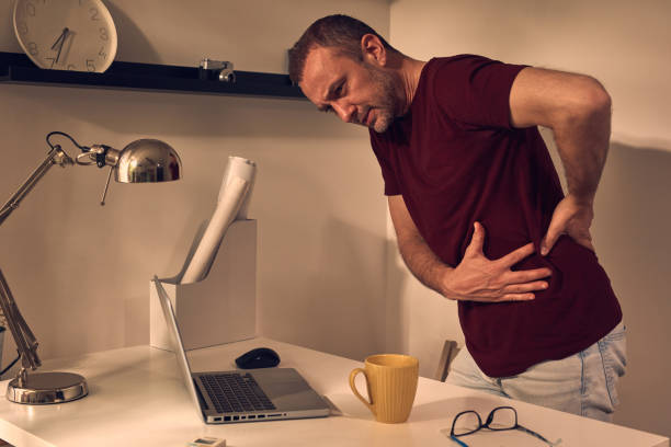 istock Man with hip, back, spine, hernia and sciatica pain at home. 1489355517