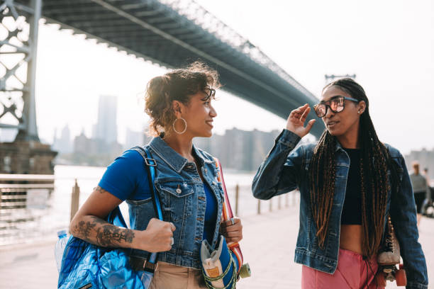 istock Two friends walking bringing roller skates on shoulder 1489355925