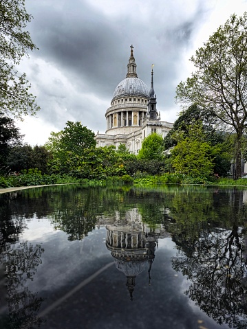 The famous dome of St Paul's cathedral reflected in the reflecting pool in the grounds of the iconic landmark.