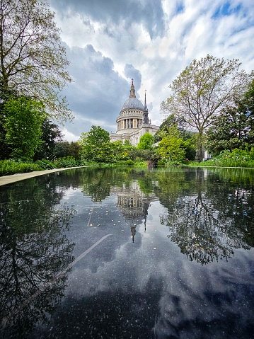 The famous dome of St Paul's cathedral reflected in the reflecting pool in the grounds of the iconic landmark.