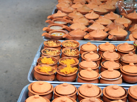 Thai custard cake in small earthenware on tray for sell in market, Thailand.