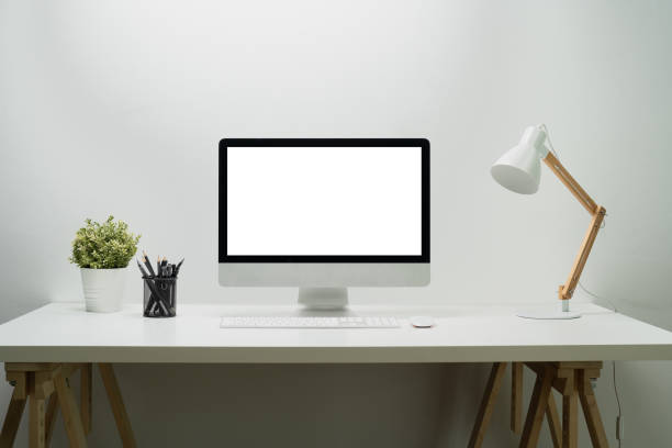 istock Modern workplace with bank screen of desktop computer on desk. White empty screen for graphic display montage. 1489358088