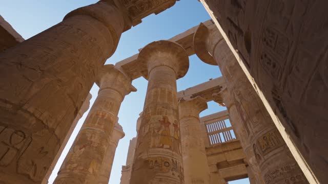Karnak Temple in Luxor, Egypt. Camera moves between majestic columns with ancient Egyptian drawings.  Gimbal high quality shot