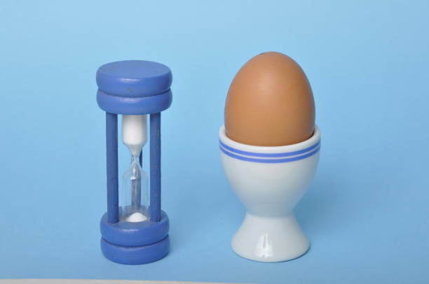 istock Boiled egg and hourglass on a blue background 1489360644
