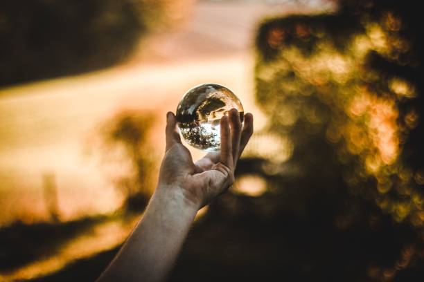 istock Person's hand holding a glass ball 1489363014