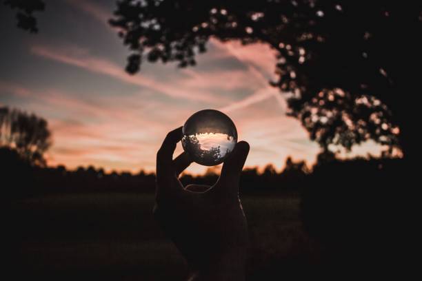 istock Person's hand holding a glass ball 1489363015
