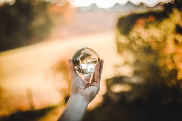 istock Person's hand holding a glass ball 1489363019