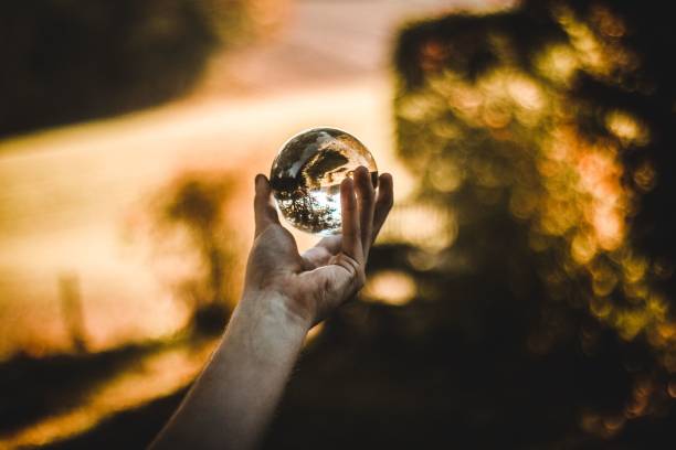 istock Person's hand holding a glass ball 1489363022
