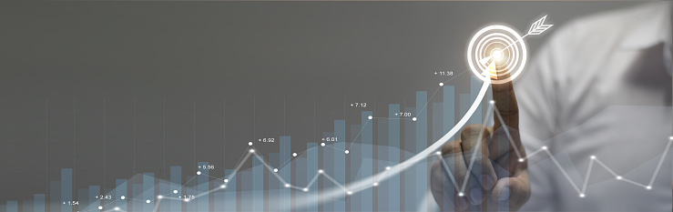 Businessman analyzing company's financial balance sheet working with digital augmented reality graphics. Businessman calculates financial data for long-term investment.