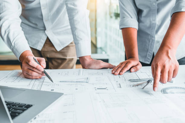 istock Team Engineer drawing graphic planning and meeting for architectural project on workplace 1489368134
