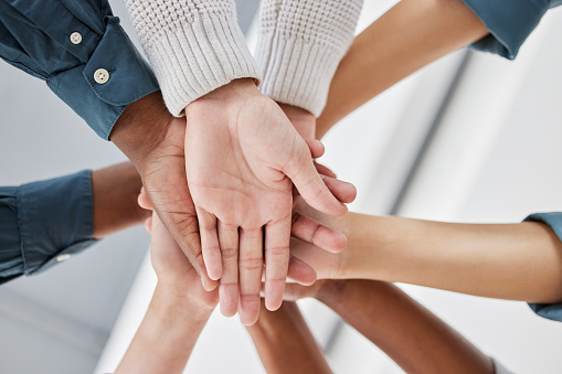 Diversity, collaboration and team stack of hands for celebration, motivation or partnership. Multiracial, teamwork and business people celebrating together for success, achievement or goal in office.