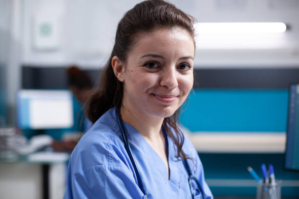 istock Cheerful nurse in office, wearing scrubs 1489371906