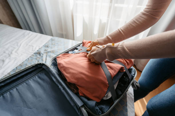 istock Young Woman Packing Luggage For A Trip 1489376357