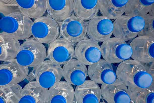 Photo of plastic pet water bottles on the shelf in the market