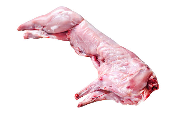 istock Whole raw rabbit on a cutting board.  Isolated on white background. 1489378575