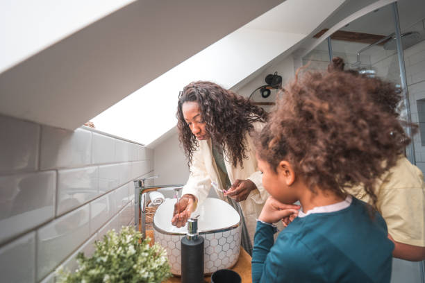 istock Mother and Her Daughters Bonding over Morning Routine 1489385956